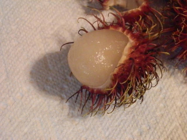 close-up of partially peeled rambutan fruit